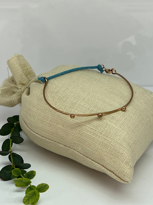 BRACCIALE IN ORO RIGIDO CON LACCETTO DI STOFFA E ZIRCONCINO AZZURRO